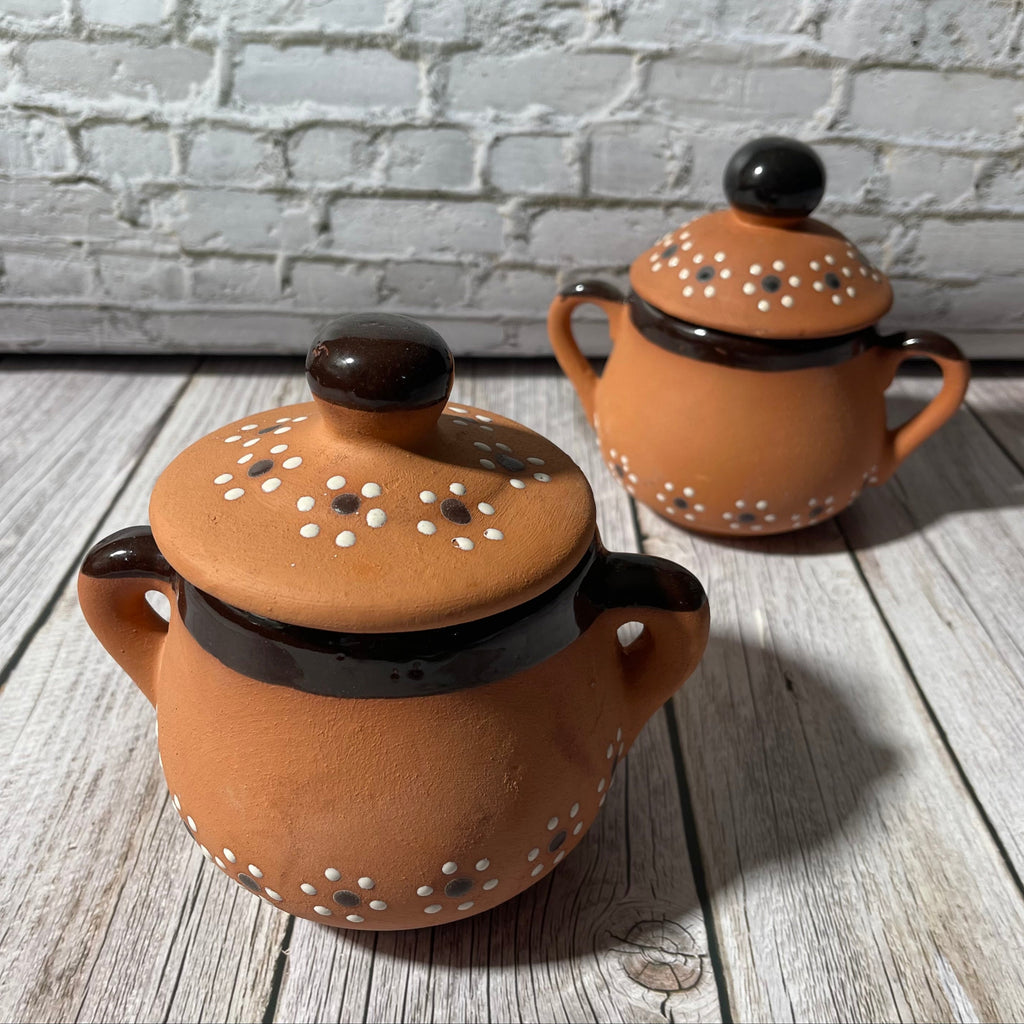 Two 16 oz handcrafted soy candles in black trimmed Mexican Clay Tacitas with lid.