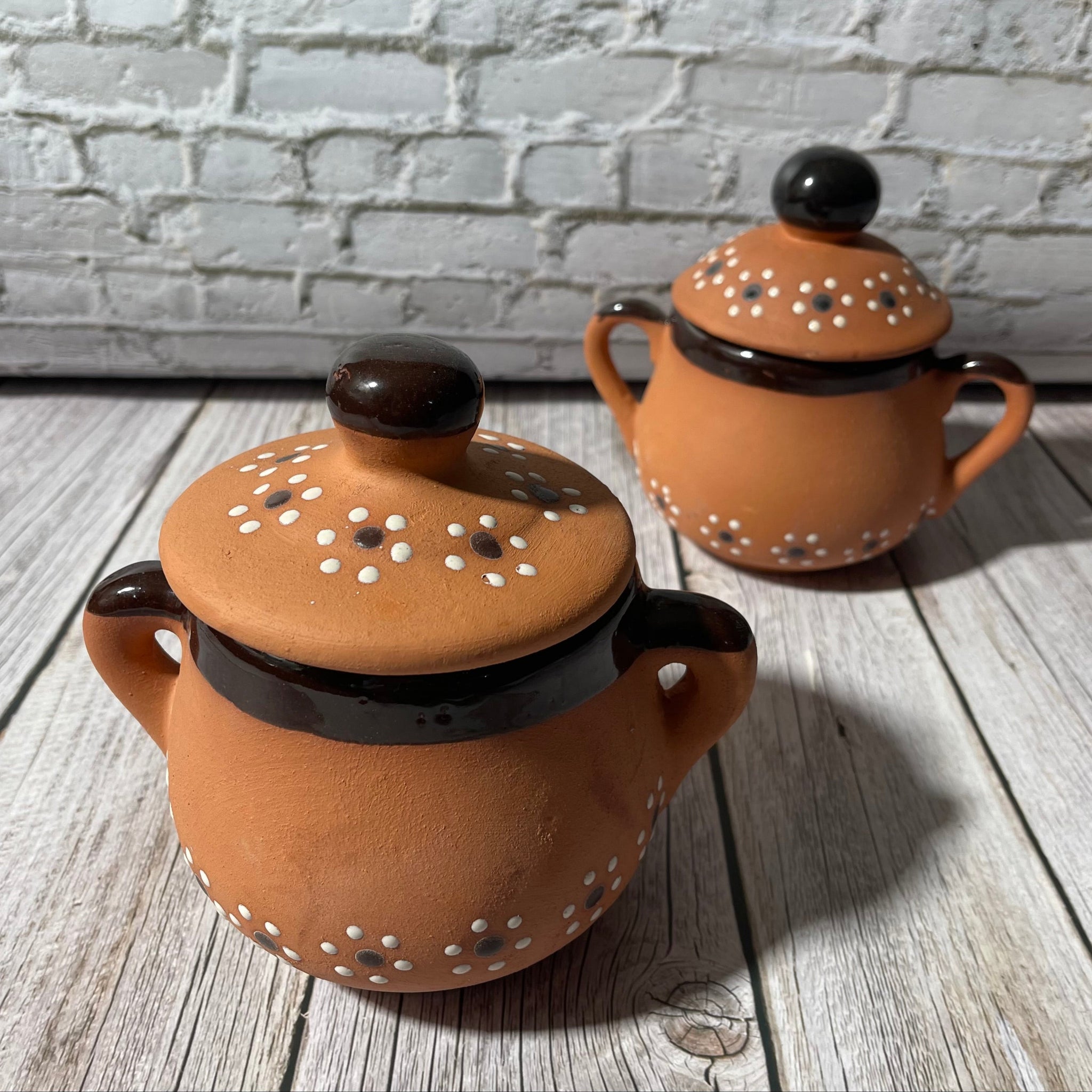 Two 16 oz handcrafted soy candles in black trimmed Mexican Clay Tacitas with lid.